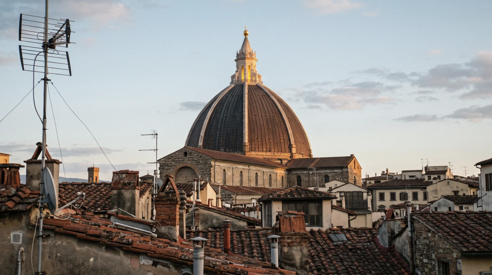 The dome of the Chapel of the Princes above the San Lorenzo rooftops in late afternoon light, Medici Chapels Florence