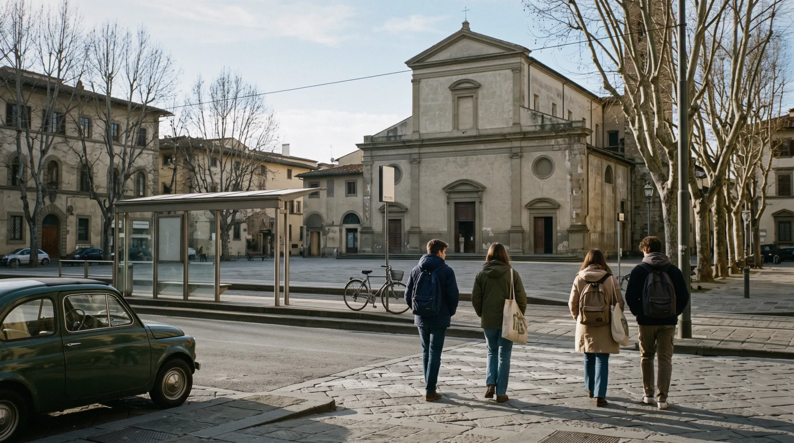 Piazza San Marco at 08:10 with the church facade, the tram platform and students crossing, San Marco district Florence