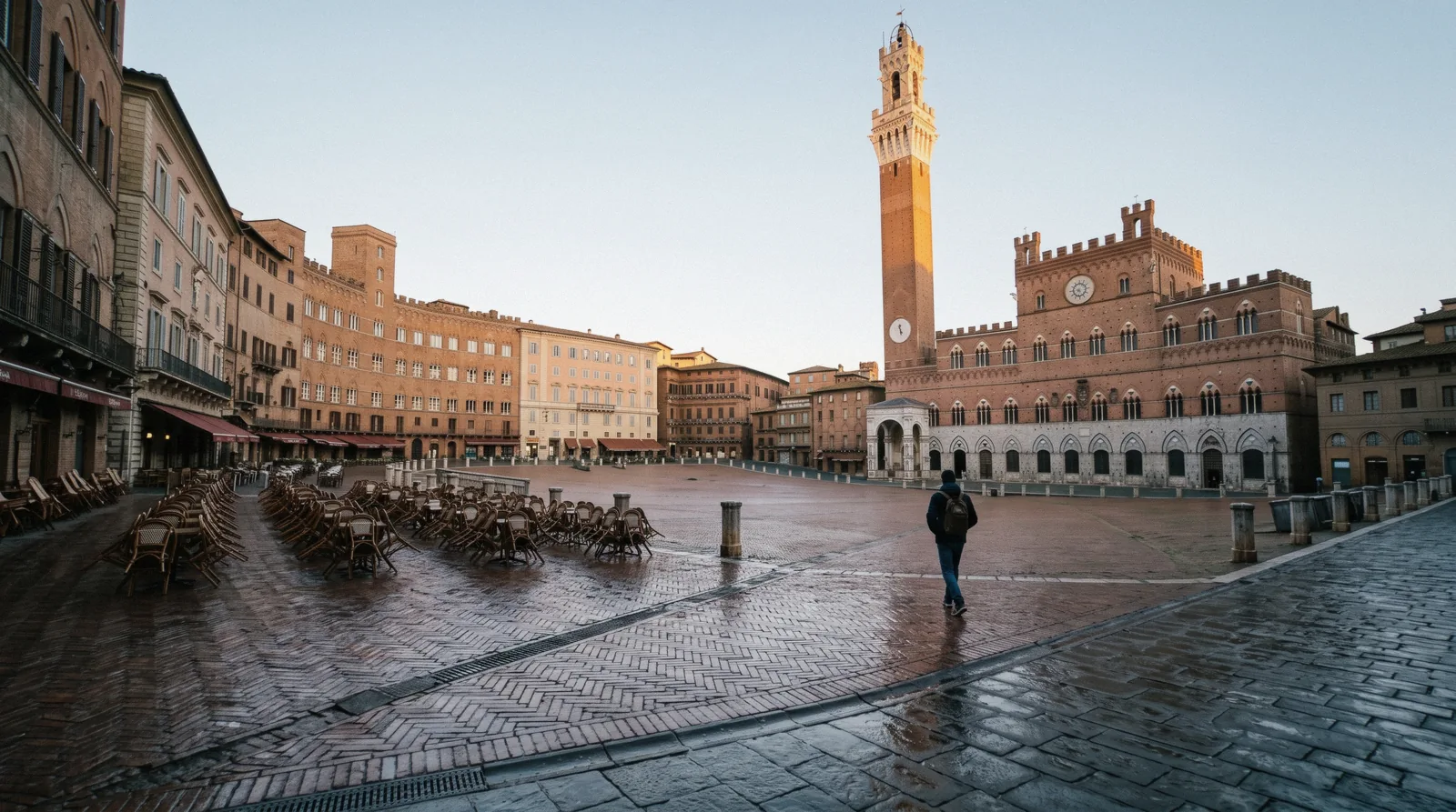 Piazza del Campo and the Torre del Mangia in early morning light at the start of a Siena day trip from Florence