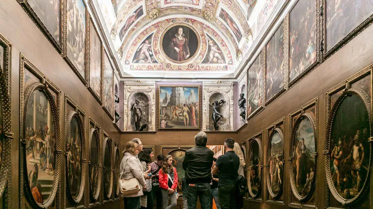 Guide opening a hidden Medici passage on a Palazzo Vecchio secret passages tour in Florence, Italy