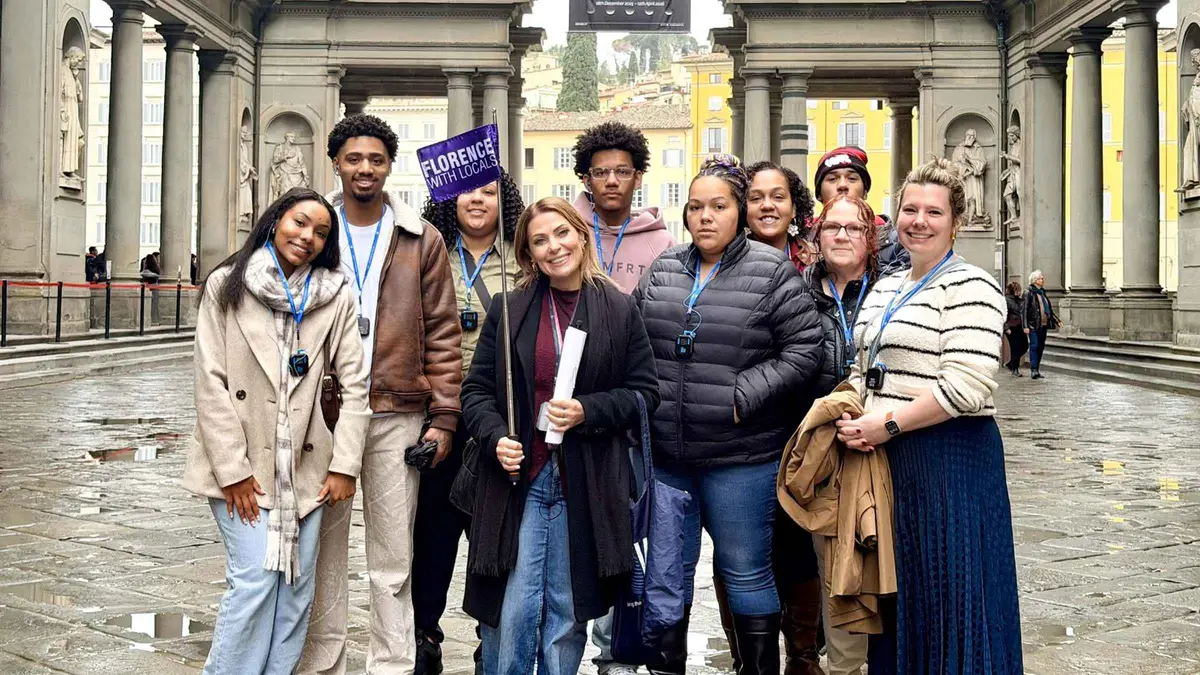 Small group entering the Vasari Corridor after an Uffizi guided tour in Florence, Italy