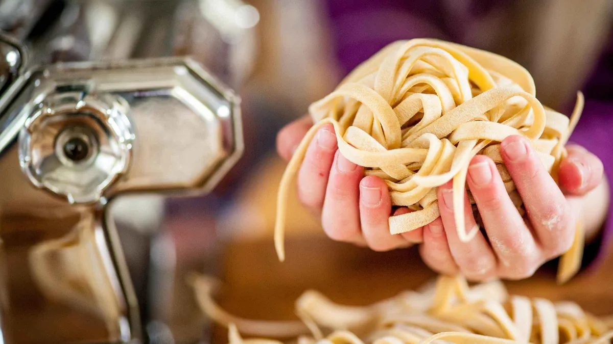Rolling ravioli in a medieval tower on a Florence pasta cooking class with unlimited wine in Italy