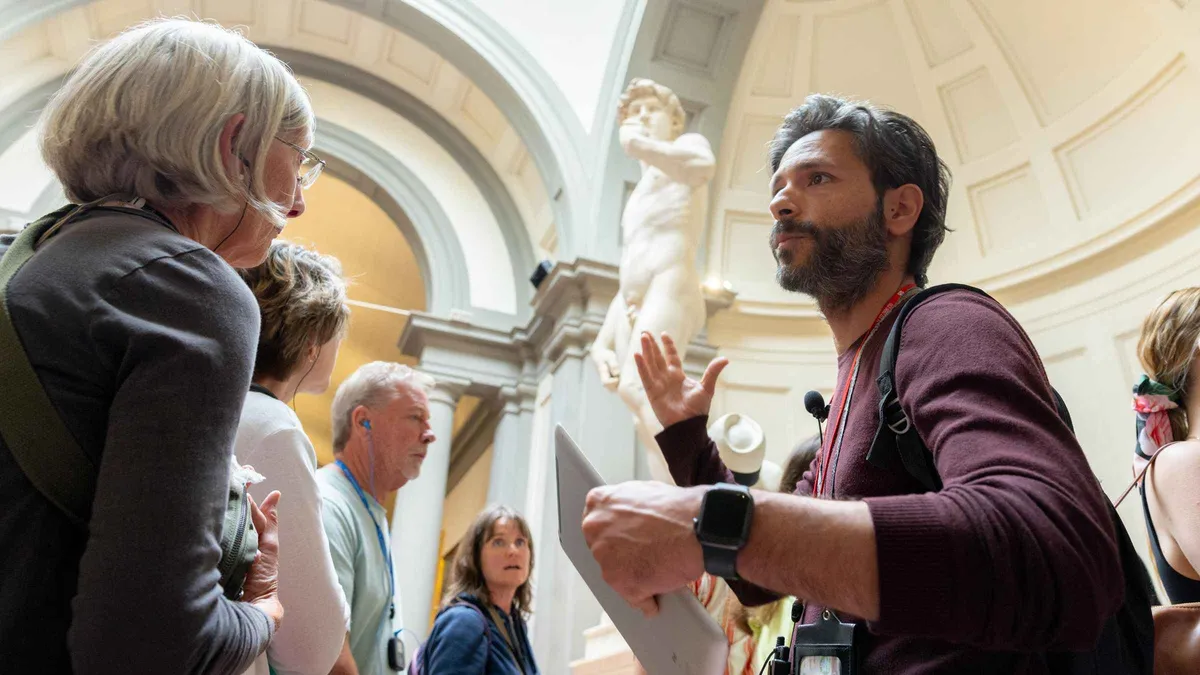 Guide explaining Michelangelo's David on an Accademia Gallery guided tour in Florence, Italy