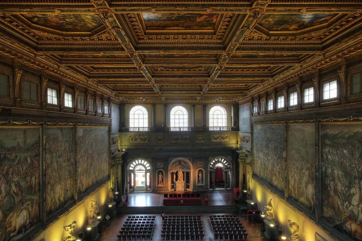 The Salone dei Cinquecento in Palazzo Vecchio, Florence, with Vasari's painted ceiling panels and battle frescoes on the long walls