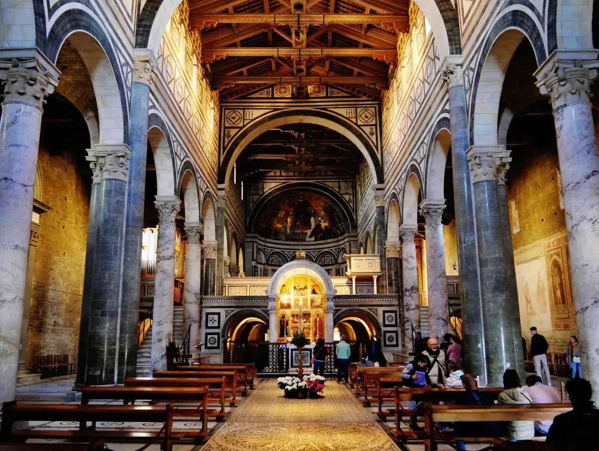 The inlaid marble nave, the Chapel of the Crucifix and the raised choir inside San Miniato al Monte, the hilltop basilica above Florence